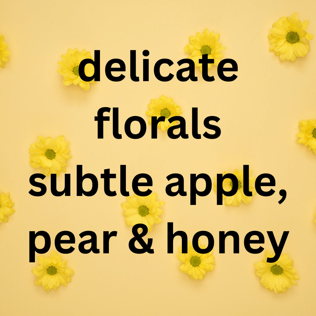 Text 'delicate florals subtle apple, pear & honey' on a yellow background with yellow flowers.